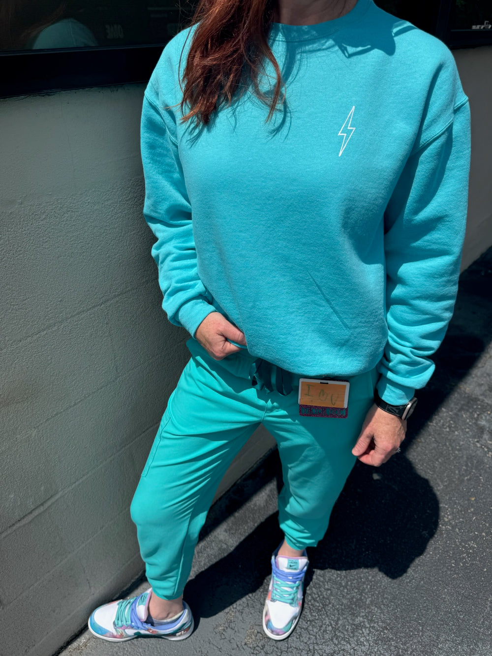 Ladyspinedoc Ladyspinedoc wearing the Big Brain Energy Crewneck Sweatshirt in Seafoam color, showing the front with lightning bolt on upper left chest. 