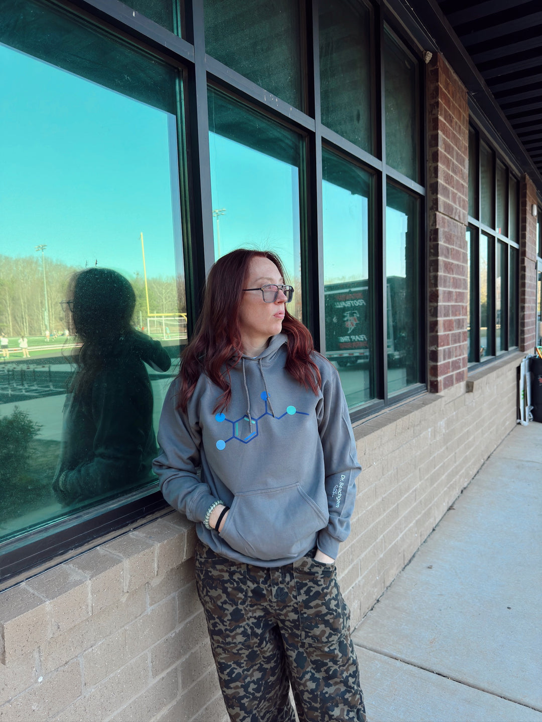 Ladyspinedoc wearing a gray Code Cart Hoodie outside