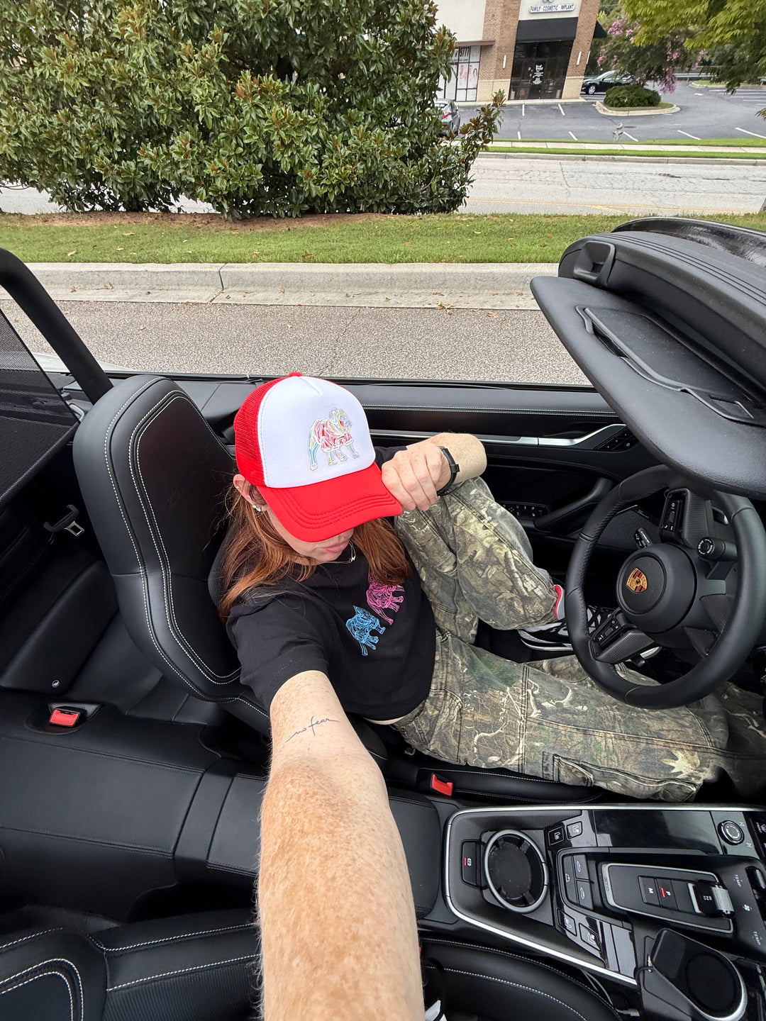 Ladyspinedoc wearing red and white  Game Day Trucker Hat - Bulldog Cap in a convertible
