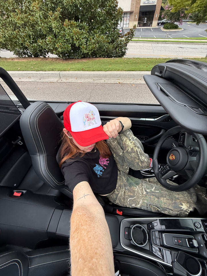 Ladyspinedoc wearing red and white  Game Day Trucker Hat - Bulldog Cap in a convertible