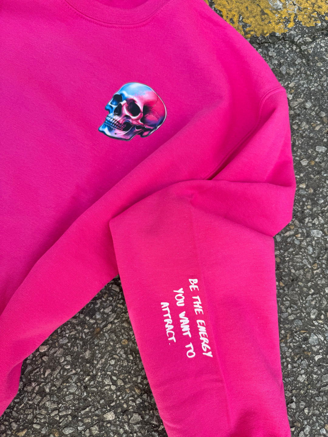 The Power Within Crewneck Sweatshirt - Pink Shirt with Skull, and Motivational "BE THE ENERGY YOU WANT TO ATTRACT" Motto on sleeve