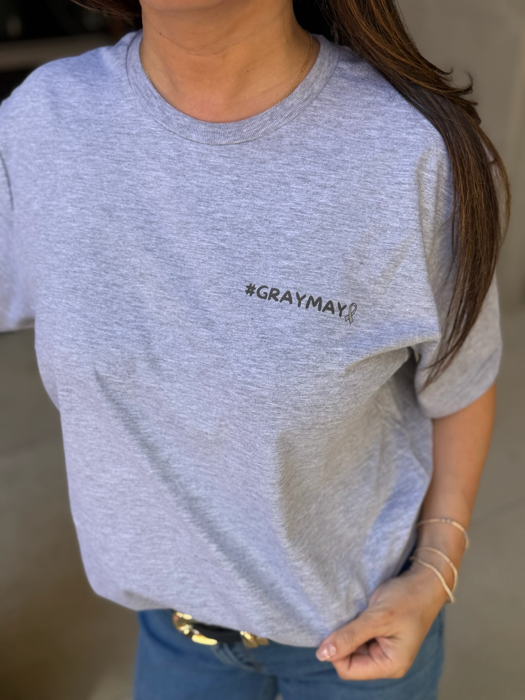 Person wearing a gray t-shirt with '#GRAYMAY' text.