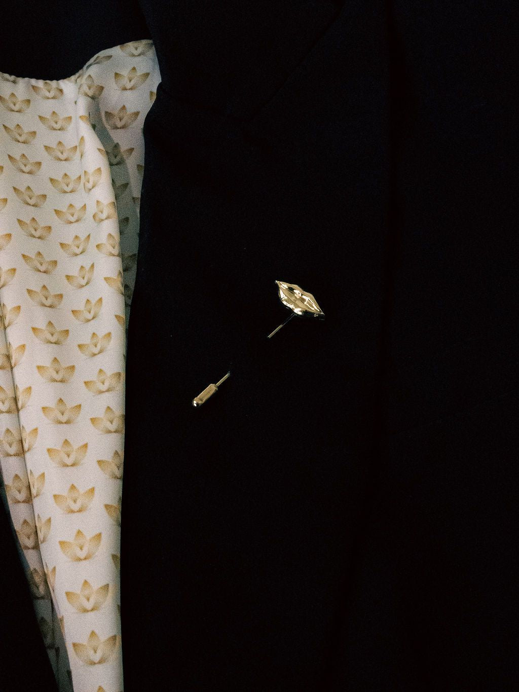 Lip lapel pin in a black jacket lapel