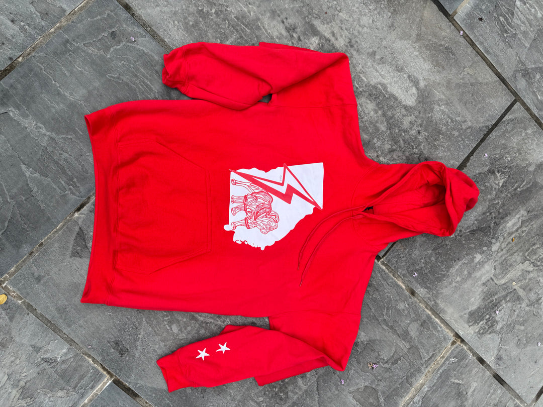 Red hoodie with a white graphic design on a gray stone surface