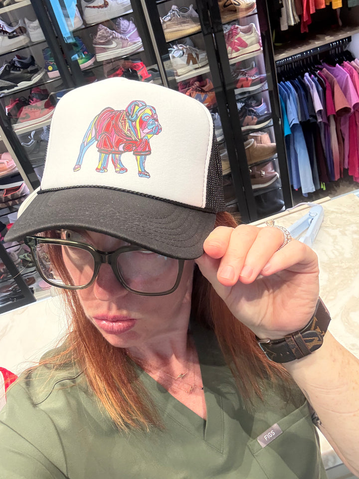 Ladyspinedoc wearing a cap with a colorful bulldog design in a store setting