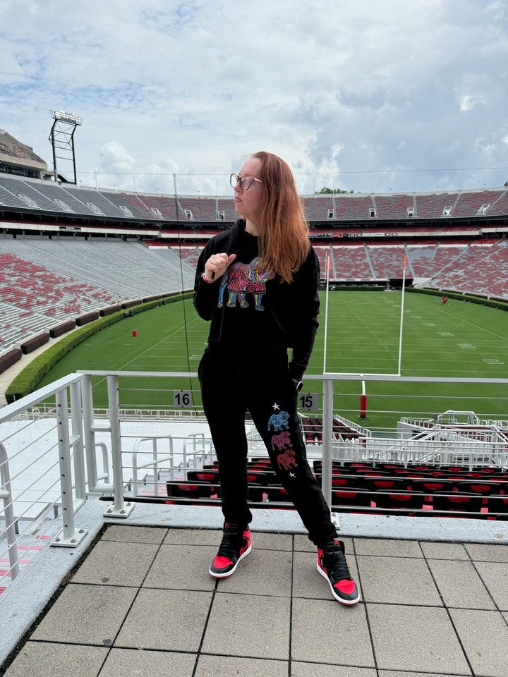 Person standing in a stadium with a view of the field wearing bulldog gear