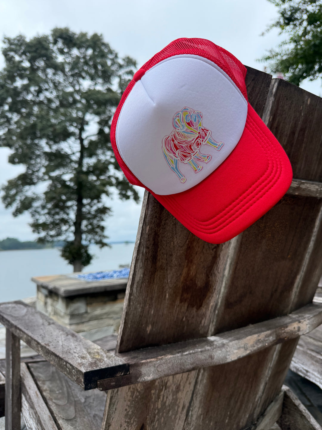Red and White Game Day Trucker Hat - Bulldog Cap hanging on back of chair.