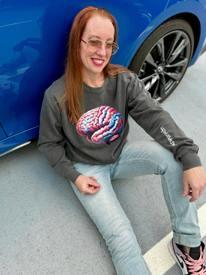 Dr. Grunch wearing a shirt with a colorful brain on the front and the Ladyspinedoc logo on the left sleeve